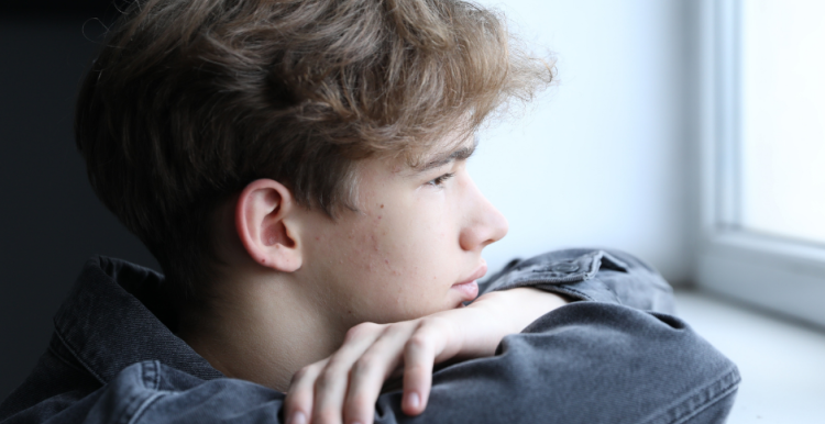 Young man looking out of a window