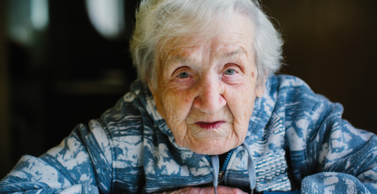 Older lady facing camera with arms crossed