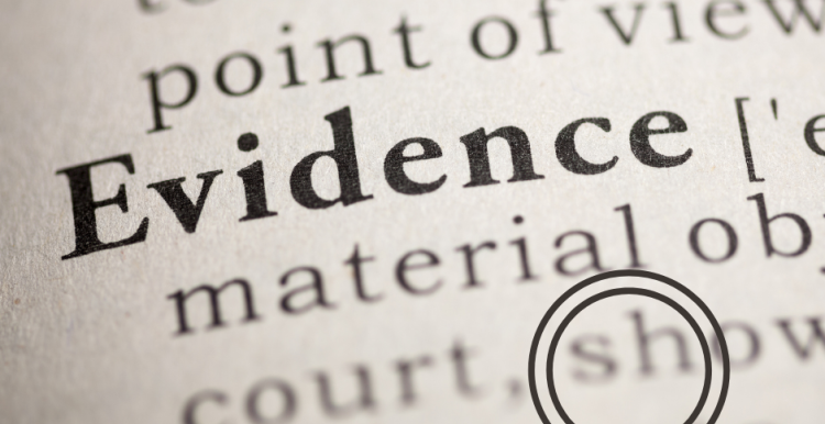 photo of a dictionary entry for 'evidence' with a small magnifying glass