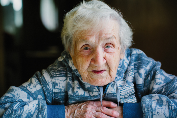 Older lady facing camera with arms crossed