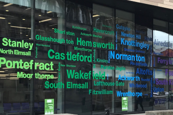 Front of Wakefield One with local place names on the windows