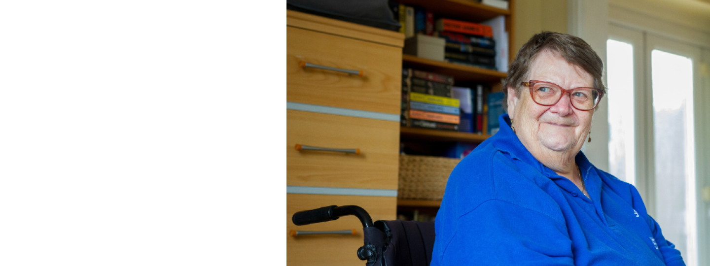 Older woman sat in a wheelchair smiling