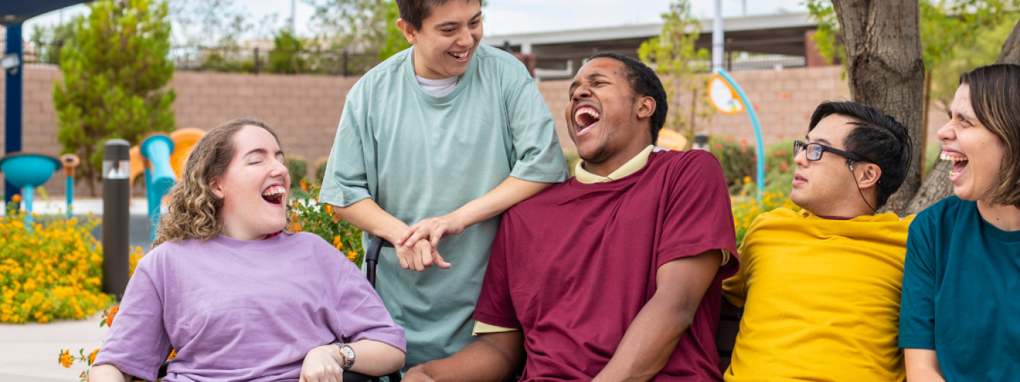 Group of people sat together laughing