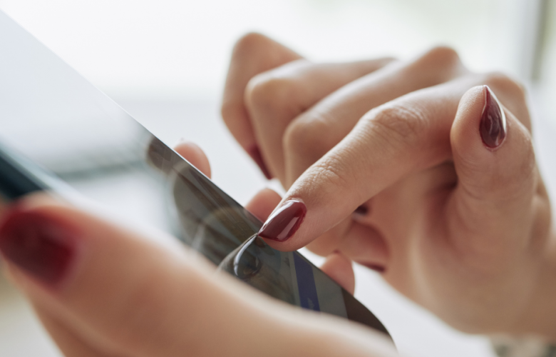 Photo of a close up of someone's hands using a mobile phone