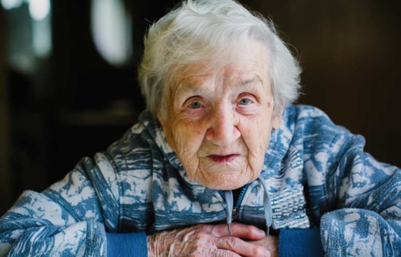 Older lady facing camera with arms crossed
